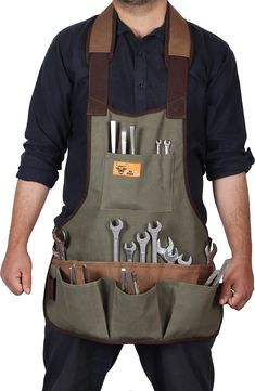 a man wearing an apron with many tools in it's pockets and his hands are holding wrenches