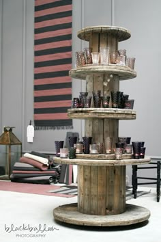 three tiered wooden stand with cups on it