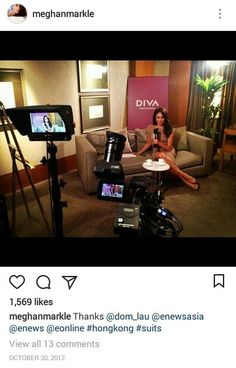 a woman sitting on top of a couch in front of a video camera next to a chair