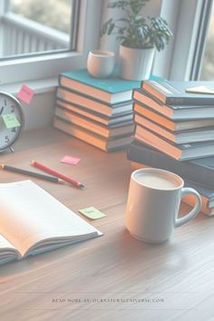 a stack of books sitting on top of a wooden table next to a coffee cup