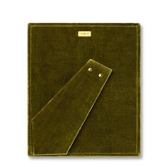 a green cloth with two buttons on the front and back of it, sitting on a white surface