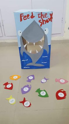 a box that has some sort of shark on the floor with cut outs in front of it