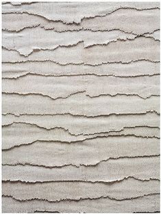 a beige rug with wavy lines on it