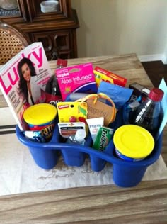 a blue container filled with lots of food and drinks sitting on top of a table