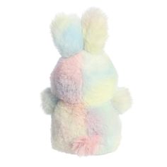 a multicolored stuffed animal sitting on top of a white surface