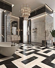 an elegant bathroom with black and white marble flooring, chandelier and large bathtub