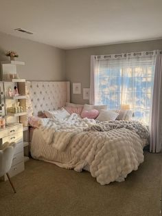 a bedroom with a bed and desk in it