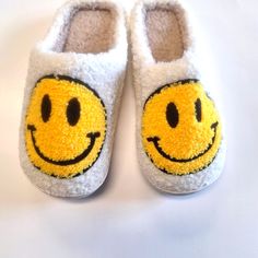 a pair of slippers with a smiley face on them