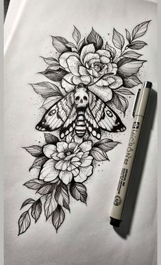 a pencil drawing of a butterfly and flowers on paper with a marker next to it