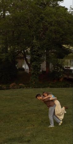 two people are playing with a frisbee in the grass