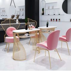 pink chairs and tables in a white room