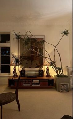 a living room filled with furniture and potted plants on top of a wooden table