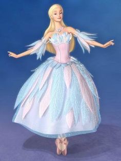 a barbie doll wearing a blue and pink dress with feathers on it's wings