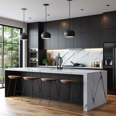 a kitchen with marble counter tops and stools next to an island in the middle