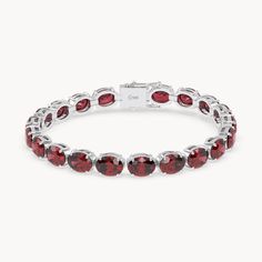 The Rouge Tennis Bracelet celebrates the passionate power of the ruby, with its deep red color reminiscent of a glowing fire. Crafted from 14kt recycled gold, the bracelet is set with oval cut rubies elegantly held in prong settings. With an impressive total carat weight of 36ct. and an intense red hue, each stone embodies passion and strength. This piece, with a width of 6 mm, is a true eye-catcher and a symbol of the fiery elegance of rubies. Luxury Red Oval Bracelet, Red Oval Tennis Bracelet Fine Jewelry, Red Oval Fine Jewelry Tennis Bracelet, Oval Ruby Gemstone Tennis Bracelet, Red Oval Tennis Bracelet For Anniversary, Classic Red Oval Diamond Bracelet, Red Oval Diamond Classic Bracelet, Red Oval Classic Diamond Bracelet, Red Oval Diamond Gemstone Bracelet