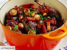 a red pot filled with food on top of a table