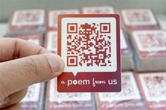 a person holding up a qr - code sticker in front of some red and white squares