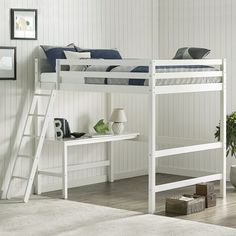 a white bunk bed sitting next to a table with a potted plant on it