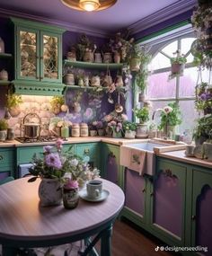 a kitchen filled with lots of green cabinets next to a wooden table and purple walls