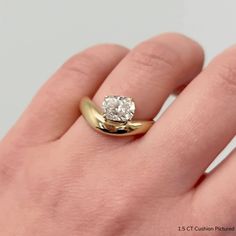 a woman's hand with a ring on it and a diamond in the middle