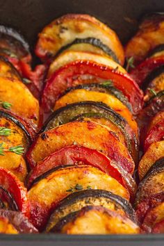 cooked vegetables in a baking dish with herbs