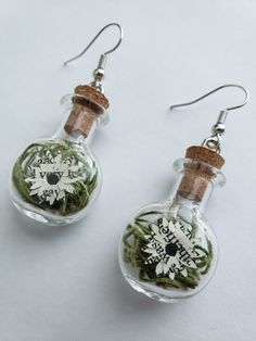 Want earrings that show off your love of books? Our Bookish Paper Flower Jar Earrings are just the thing you need to take your literary love with you wherever you go! Whether you're attending a book club meeting or a gallery opening, these earrings effortlessly elevates your style while expressing your appreciation for the written word. Experience the fusion of art and literature by ordering the Bookish Paper Flower Jar Earrings today!   Note: Due to the artisanal nature of the crafting process, each keepsake may exhibit subtle variations from the photo samples, creating a truly unique accessory. All items from Novel Blossoms Co are made-to-order, so we do not start creating your art piece until it is ordered. Please allow 5-10 business days for us to handcraft your keepsake before we ship Jar Earrings, Flower Jar, Gallery Opening, Book Club Meeting, Flowers In Jars, Art And Literature, The Thing, Accessories Unique, Book Club