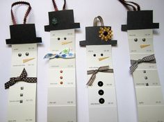 four snowmen made out of different types of buttons and ribbons, each with an ornament