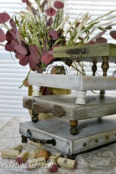 an old scale with flowers in it sitting on a table