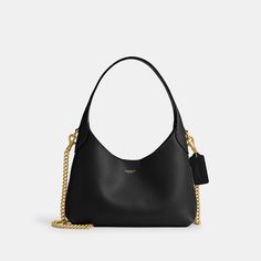 Our Brooklyn is an elegant minimalist silhouette—with a distinctly New York attitude. A compact silhouette with an easy magnetic closure the hobo style is crafted of natural grain leather with beautiful texture and soft feel. Featuring room for the essentials and a multifunction pocket for organization carry it by hand or attach the elegant chain strap to wear on the shoulder or crossbody. | Coach Brooklyn Shoulder Bag 23 - Women's Purses - Brass/black Coach Black Purse, Coach Brooklyn, Women's Purses, Black Coach Purse, Crossbody Coach, Minimalist Silhouette, Hobo Style, Black Gift, Black Purses