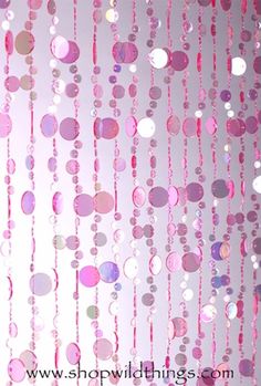 pink and white polka dot curtains hanging from the ceiling