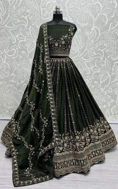 The Indian Wear Green Satin Lehenga Choli is a striking ensemble that effortlessly blends tradition with contemporary elegance. Crafted from luxurious satin fabric, this ensemble exudes sophistication and charm. Satin Lehenga Choli, Dark Green Lehenga, Satin Lehenga, Pakistan Clothes, Heavy Lehenga, Choli For Women, Lehenga Choli Wedding, Desi Wedding Dresses