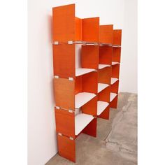 an orange shelving unit with white shelves on each side and one shelf in the middle