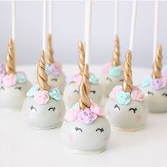 some cake pops with unicorn heads on them