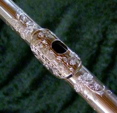 a close up view of the top of a flute with filigrees on it