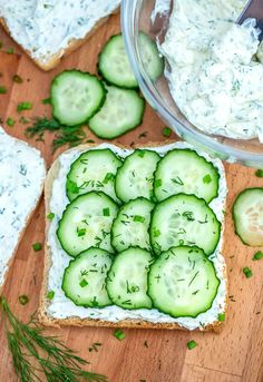 cucumber slices are arranged on top of bread with dill in the middle