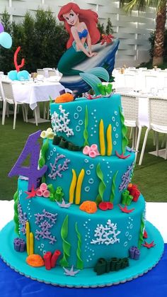 the little mermaid cake is decorated with fondant and under water decorations, including corals