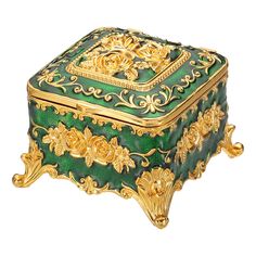 an ornate green and gold box with flowers on it's sides, set against a white background