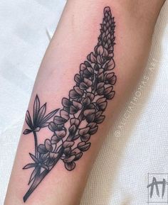 a black and white flower tattoo on the arm