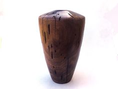 a wooden vase sitting on top of a white table