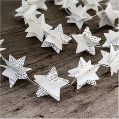 paper stars are strung with string on a wooden table