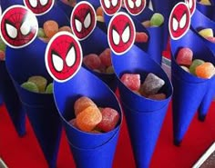 there are many candy cones with spiderman faces on them