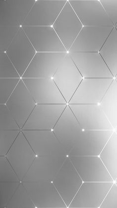 an abstract silver background with lines and dots on the wall, as well as lights