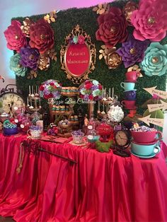 a table topped with lots of different types of flowers and desserts on top of it