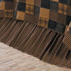 a brown and black checkered quilt on a bed