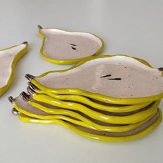 three yellow and white dishes sitting on top of each other