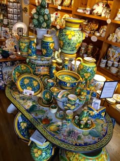 there are many vases and bowls on display in the store, including one for sale