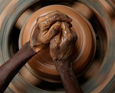 two hands on a potter's wheel with a quote from tosca on writing