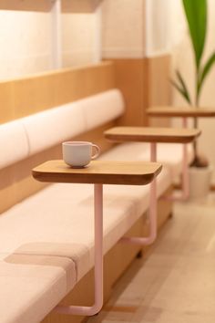 three tables with cups on them are lined up next to each other in a waiting area