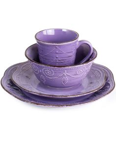 three purple cups and saucers sitting on top of each other