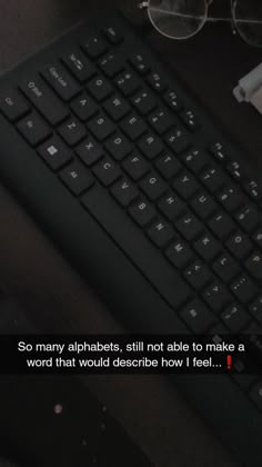 a computer keyboard sitting on top of a desk next to a cup of coffee and glasses